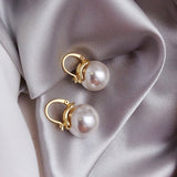 Thick earrings with pearls in gold