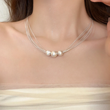 Elegant collar with layers of white pearls