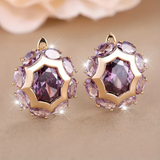 Round gold earrings with violet zirconia